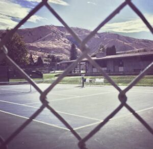 fenced tennis court